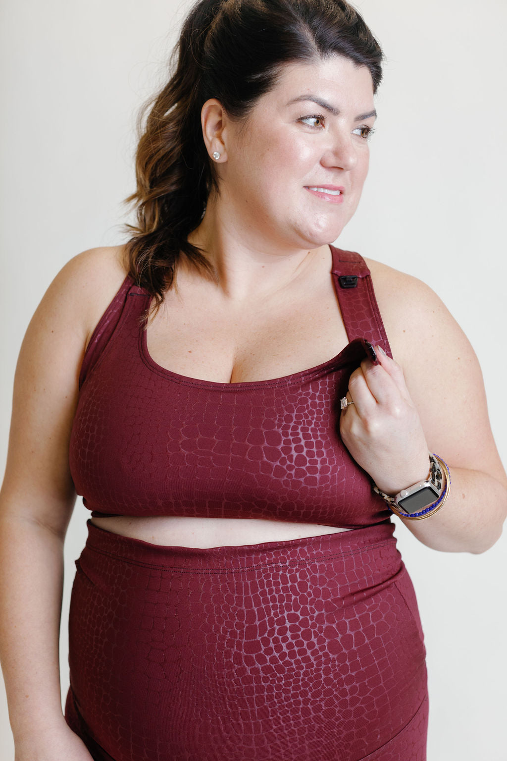 Fig colored maternity activewear nursing sports bra with mesh-back design and an adjustable band with hooks. 