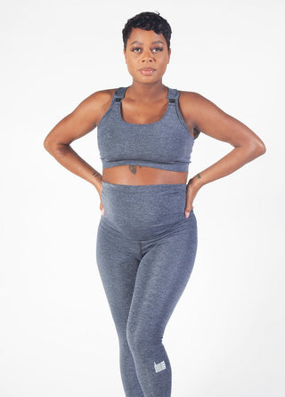 Grey colored maternity activewear nursing sports bra with mesh-back design and an adjustable band with hooks.
