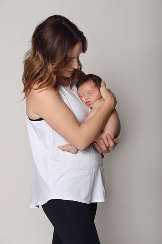 White racerback maternity activewear and postpartum workout tank with white lettering